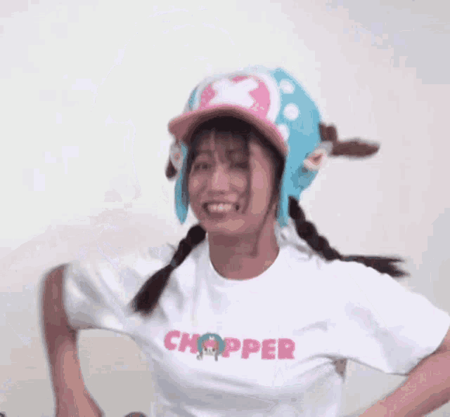 a woman wearing a chopper t-shirt and a chopper hat