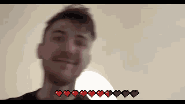 a blurry picture of a man 's face with hearts on it