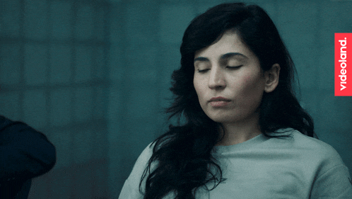 a woman with her eyes closed and a videoland logo in the corner