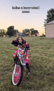 a woman is riding a dirt bike in a field with the words ladies u know what i mean