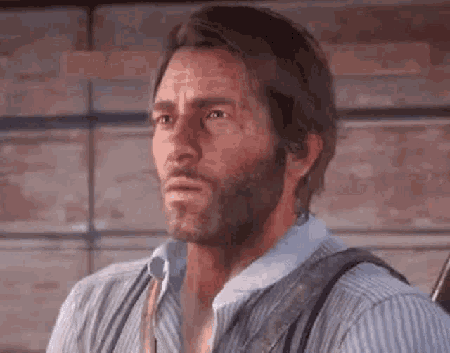 a man with a beard and suspenders is looking at the camera .