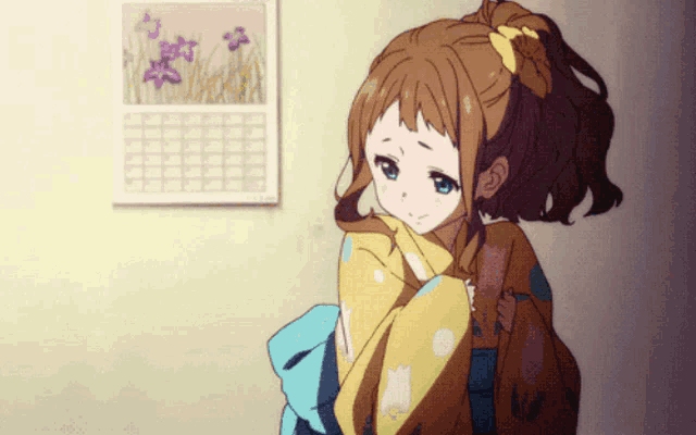 a girl in a ponytail is standing in front of a wall calendar