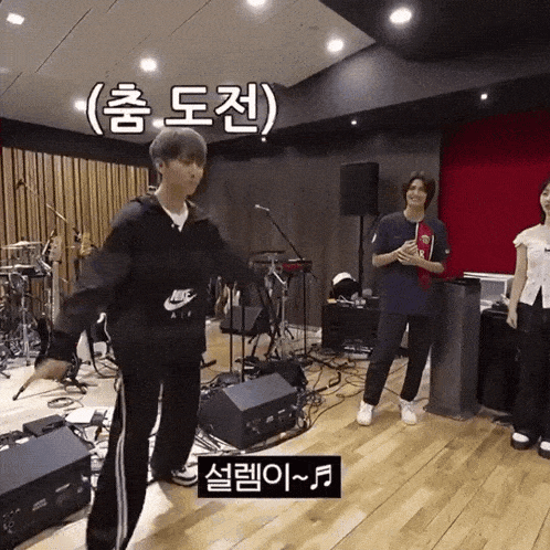 a man wearing a nike air hoodie is dancing in a room
