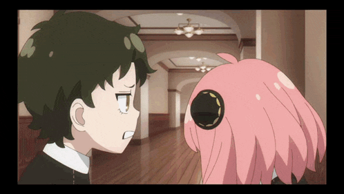 a boy and a girl are looking at each other