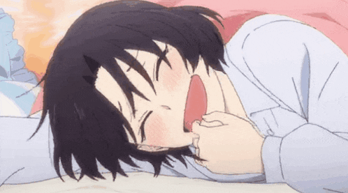 a girl is sleeping on a bed with her mouth open and her eyes closed .