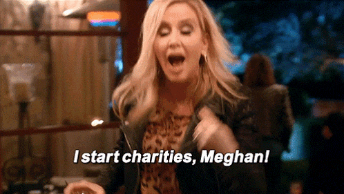a woman is holding a glass of wine and shouting i start charities , meghan !