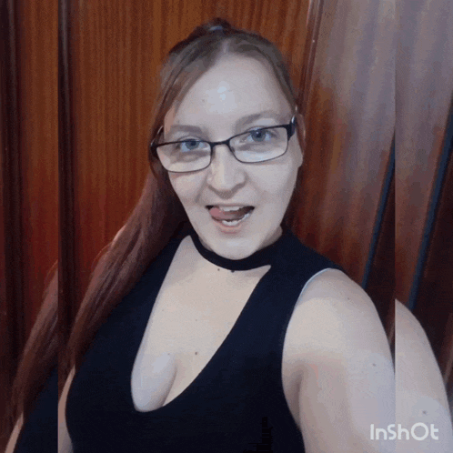 a woman wearing glasses and a choker is making a funny face in an inshot photo