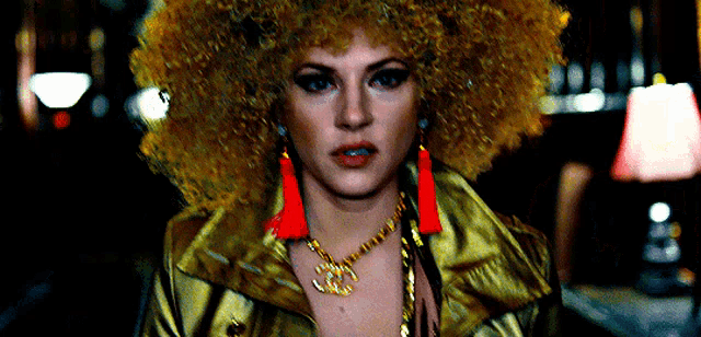 a woman wearing a necklace with a chanel logo