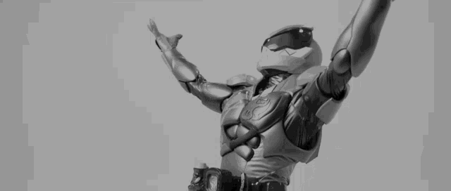a black and white photo of a futuristic robot with its arms outstretched
