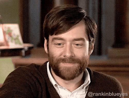 a man with a beard is smiling with the hashtag rankinblueeyes visible