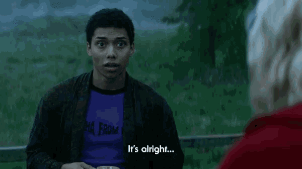 a man wearing a purple shirt that says " to be a little nervous " talks to a woman