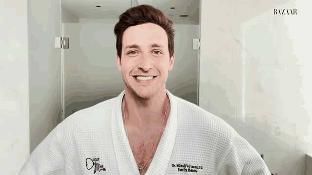 a man wearing a white bathrobe with the name dr. wilhelm verberg on the front