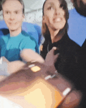 a blurry picture of a man and a woman sitting next to each other