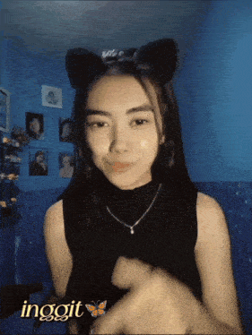 a girl wearing a cat ear headband with the word ingoit written on it