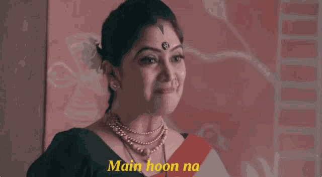 a woman with a nose ring is smiling with the words main hoon na written below her