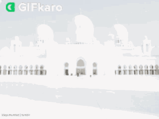 a gif of a mosque with the words eid mubarak written on it