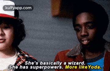 a couple of boys are standing next to each other and one of them is talking about a wizard .