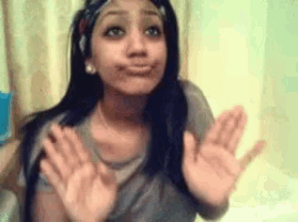 a woman making a face with her hands in the air