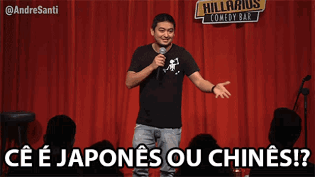a man stands on a stage with a microphone in front of a sign that says hilarious comedy bar