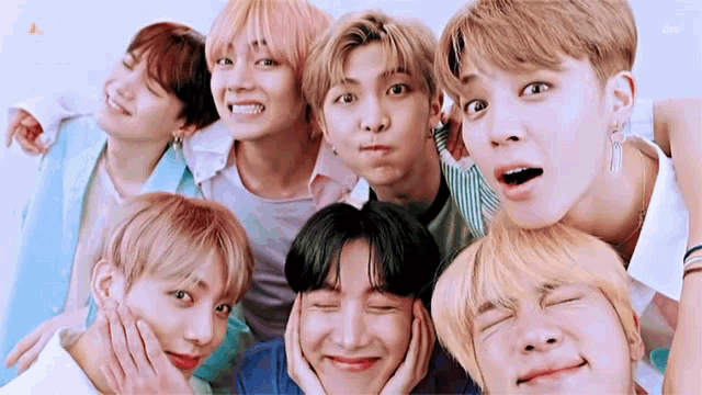 a group of young men are posing for a picture and one of them has his eyes closed