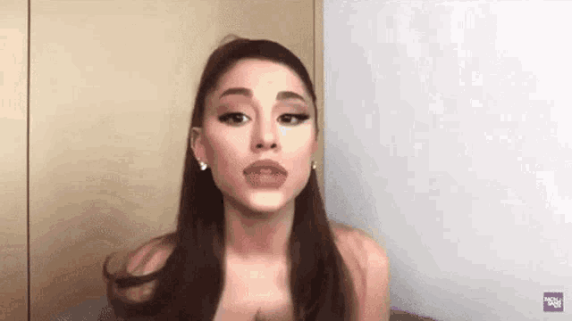 ariana grande is making a funny face while talking to a camera .