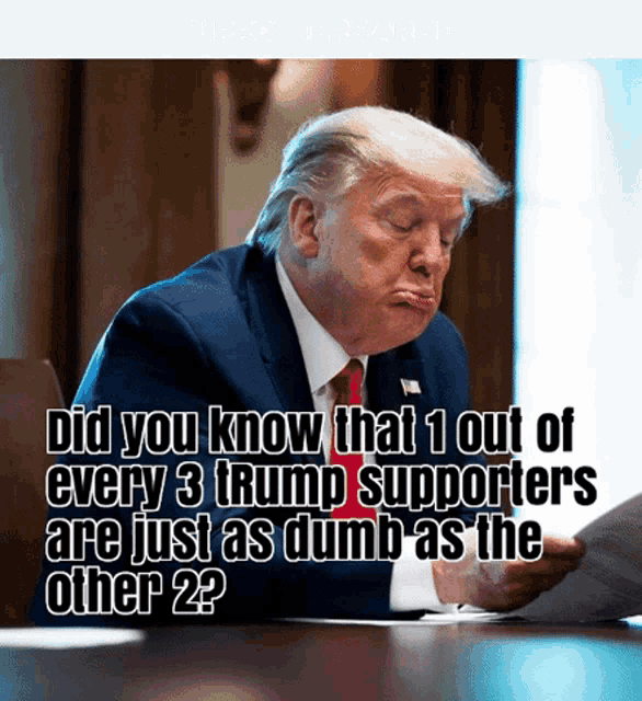 donald trump is sitting at a table reading a piece of paper and making a funny face
