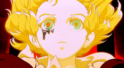 a cartoon girl with yellow hair and green eyes has a tear coming out of her eye