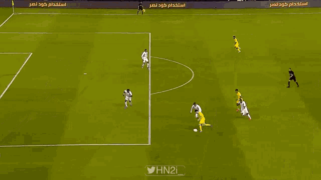 a soccer field with a banner for etihad
