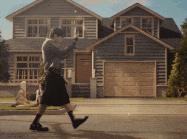 a person walking in front of a large house