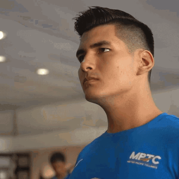 a man in a blue shirt that says mptc