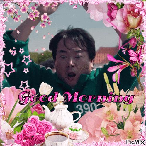 a man in a green sweatshirt is surrounded by flowers and says good morning