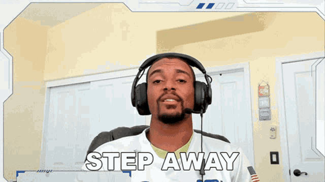 a man wearing headphones says " step away " in a video