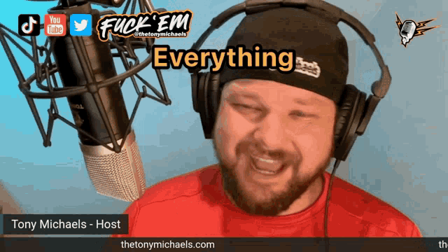 a man wearing headphones and a beanie says " everything "
