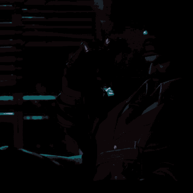 a man in a suit is sitting in front of a window with blinds open
