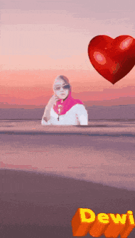 a picture of a woman with a red heart and the name dewi on it