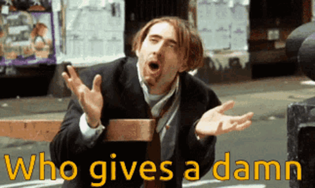 a man in a suit and tie making a funny face with the words who gives a damn below him