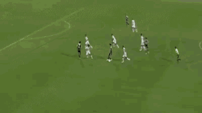a group of soccer players are playing on a field with a banner behind them that says ' slazenger '