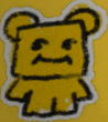 a drawing of a yellow teddy bear with a sad face