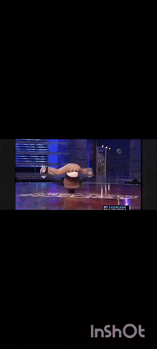 a person is doing a handstand on a stage in a video that says inshot