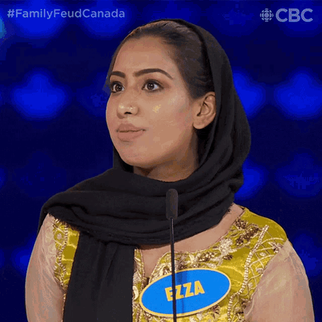 a woman wearing a hijab and a name tag that says ezza