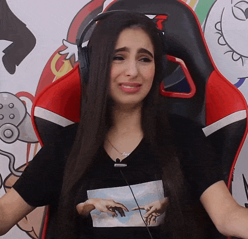 a woman wearing headphones is sitting in a chair