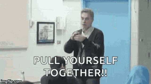 a man is giving a presentation in front of a group of people in a classroom and says `` pull yourself together ! ''