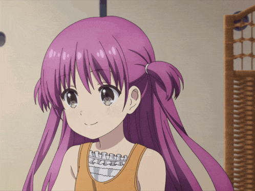 a girl with purple hair is wearing a tank top and smiling