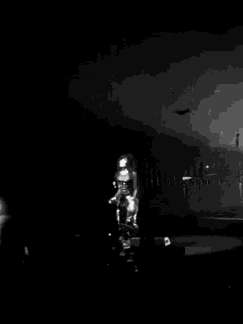 a black and white photo of a man on a stage with a sign in the background that says ' a '