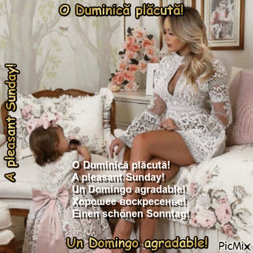 a woman in a white dress sits on a bed next to a little girl in a pink dress