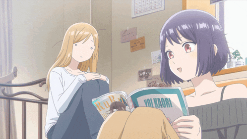 two anime girls are sitting on a bed and one is reading a magazine that says " ruru "