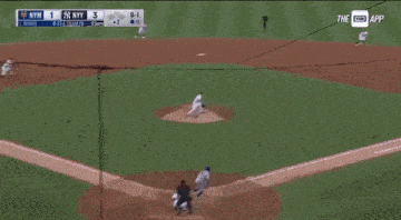 a baseball player wearing a ny yankees jersey and hat is standing on the field .