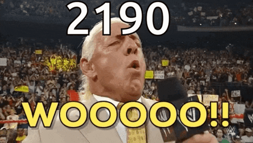a man in a suit and tie stands in front of a crowd and says 2190 wooooo !