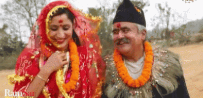 a man and a woman are standing next to each other in a field .