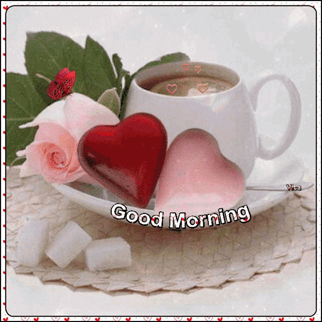 a cup of coffee with two hearts on a saucer and the words good morning